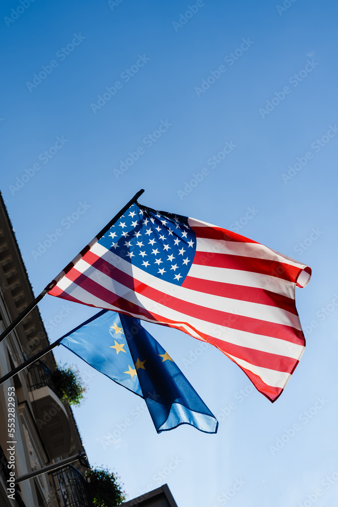 Flags of USA and European union on the building of united states embassy.