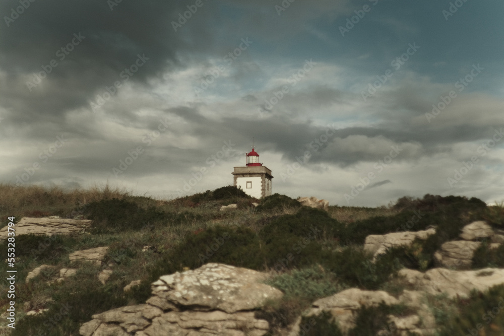 The Tip of Cabo Carvoeiro Lighthouse Tower on the Coast of Portugal, With Dark Cloudy Sky, Rainy Weather, Near Ocean