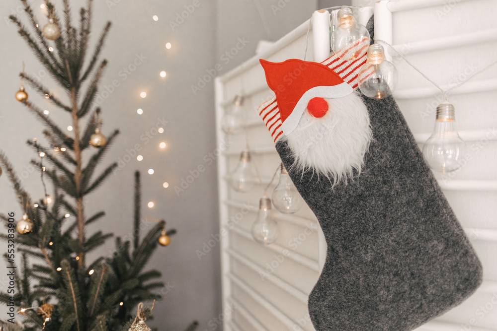 Fototapeta premium christmas stocking with gifts near the Christmas tree