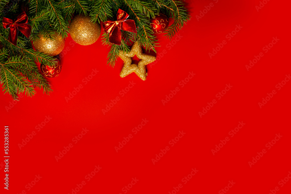 Christmas background . Festively decorated spruce branches on a red banner. Flat lay style.