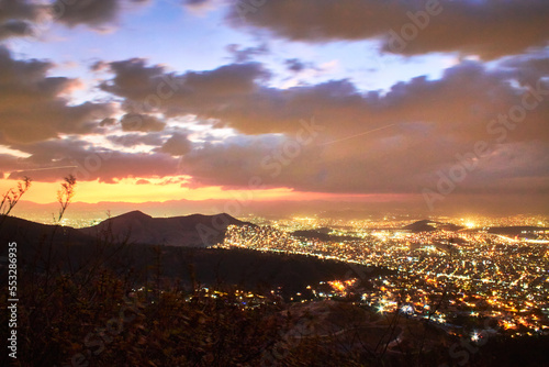 aereal view from a mountain in the evening with bright lights of the city, sierra de guadalupe state of mexico and mexico city  photo