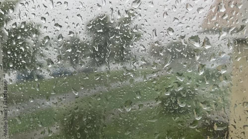 close-up raindrops flow down the glass. rain and hurricane outside close-up raindrops flow down the glass. rain and hurricane outside
