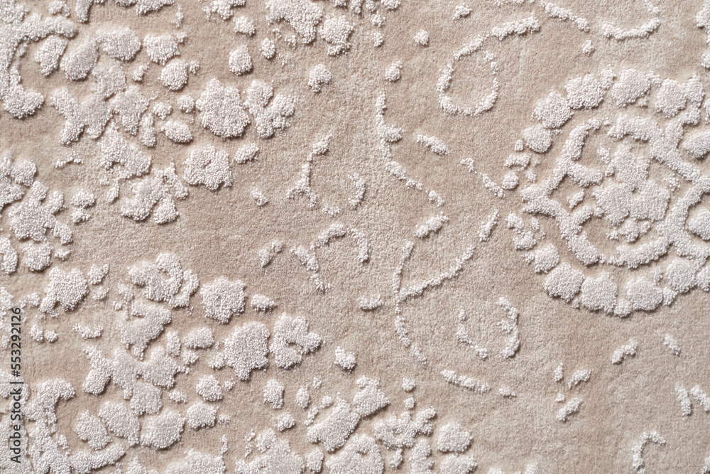 Fragment of decorative velours carpet fabric pattern, background photo texture. Close up of geometric beige and white short pile carpet ornament, upholstery fabric. Backgrounds and textures concept. Fragment of decorative velours carpet fabric pattern, background photo texture. Close up of geometric beige and white short pile carpet ornament, upholstery fabric. Backgrounds and textures concept.