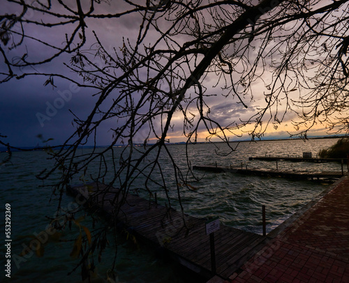A sunset on a lonely pier on a cloudy day