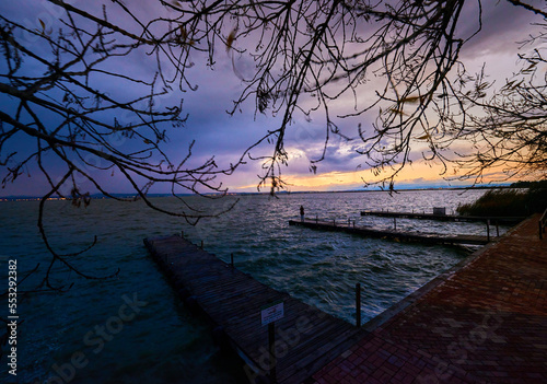 A sunset on a lonely pier on a cloudy day