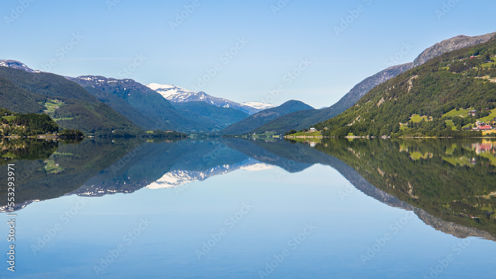 Idyllic blue lake with mountain landscape in Norway on a summer day