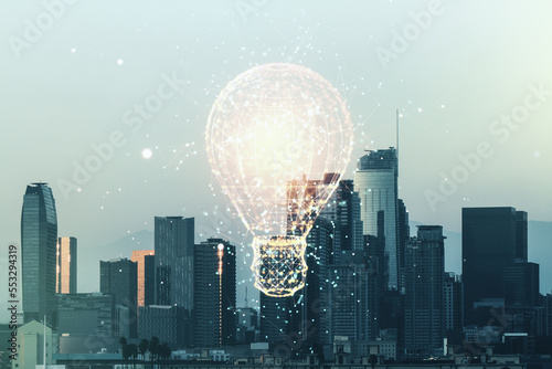 Double exposure of creative light bulb hologram on Los Angeles city skyscrapers background, research and development concept
