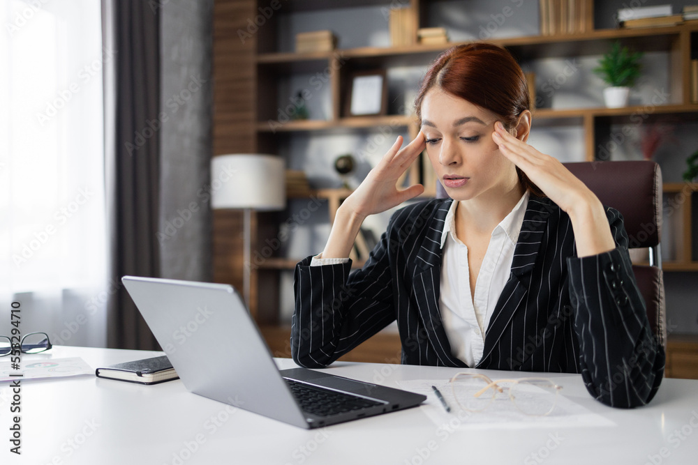 Stressed puzzled caucasian red hair businesswoman with closed eyes feeling headache, sitting in office, exhausted upset employee reading bad news in email, having problem with difficult online project Stressed puzzled caucasian red hair businesswoman with closed eyes feeling headache, sitting in office, exhausted upset employee reading bad news in email, having problem with difficult online project