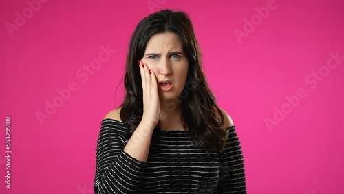 Portrait of young hipster woman 20s with tooth dental ache pain problem in mouth isolated on pink background in studio