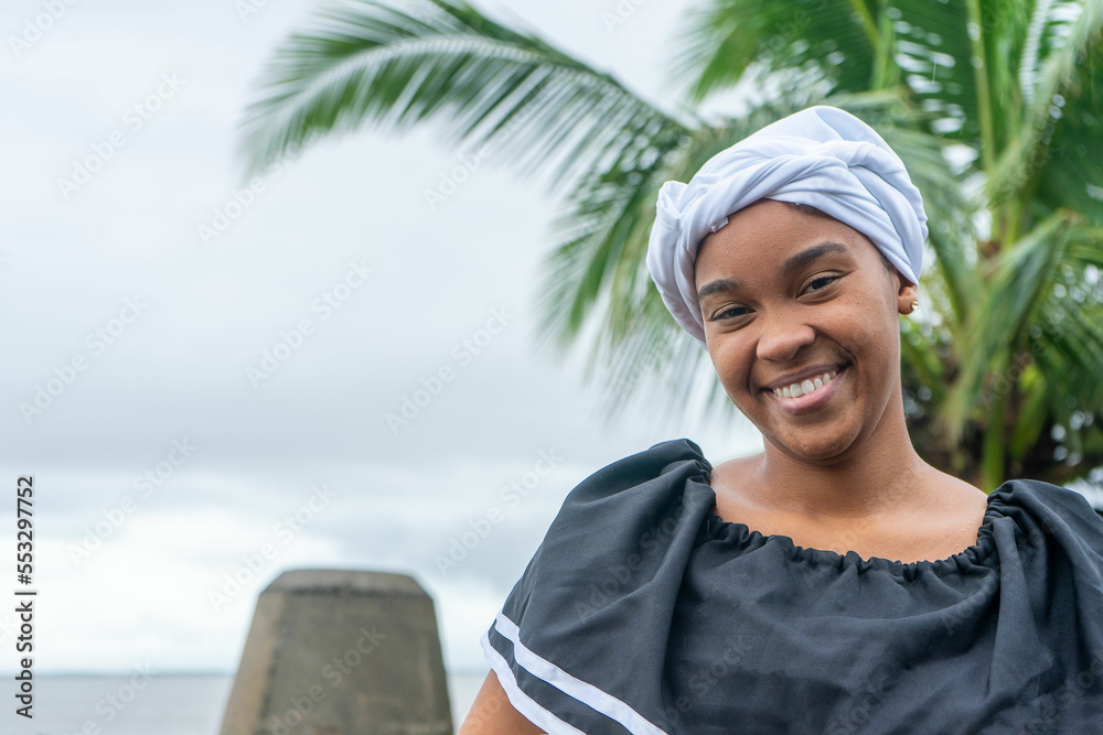 Portrait of a Nicaraguan Caribbean Afro-descendant woman smiling and looking at camera with copy space - obrazy, fototapety, plakaty 