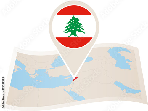 Folded paper map of Lebanon with flag pin of Lebanon.