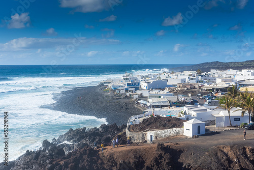 Lanzarote, Spain, 20 March 2022: The white town of El Golfo on the Atlantic Ocean photo