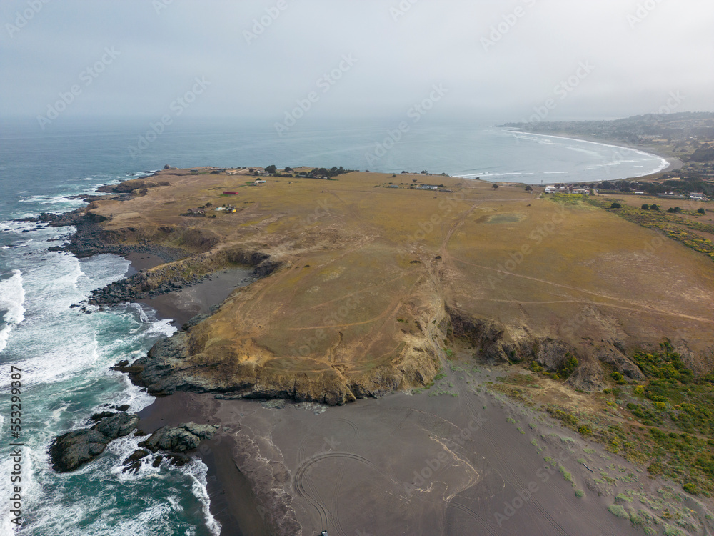Aerial shot of the pacific ocean, beach and the bay La Pancora at Pichilemu, Chile