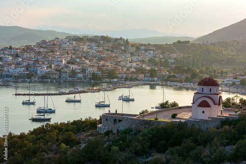 Beautiful view of Ermioni sea lagoon with moored yachts and boats at sunset time.