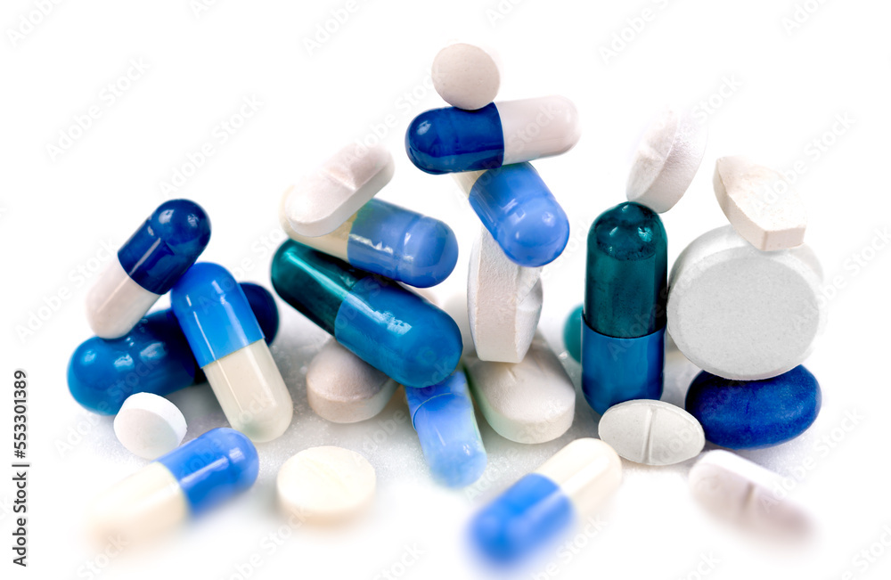 Blue capsules and hidden white in close-up on a cropped white background. Blue capsules and hidden white in close-up on a cropped white background.