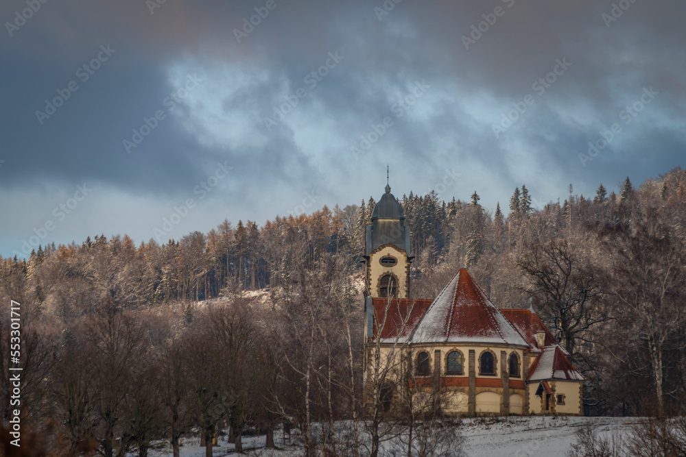 Old church and houses in Liberec city in winter snowy day