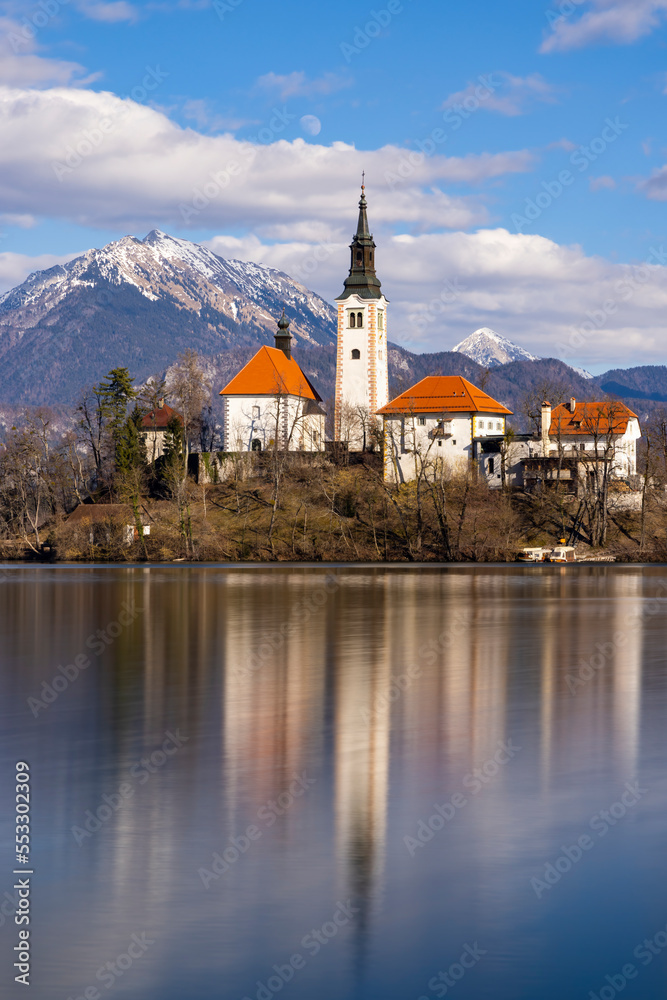 Bled lake with a church and winter Julian Alps
