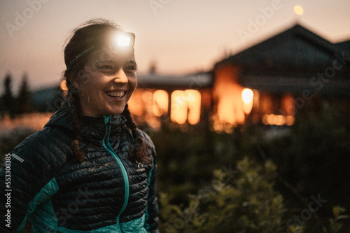 Ridge over the Slovakia mountains mala fatra. Hiking in Slovakia mountains landscape. Woman standing under the starry night sky, lighting with head lamp