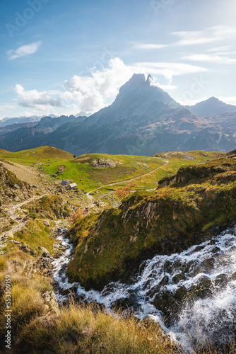 Pic du midi d Ossau with a waterfall and grass in the foreground  Pyrenees   France