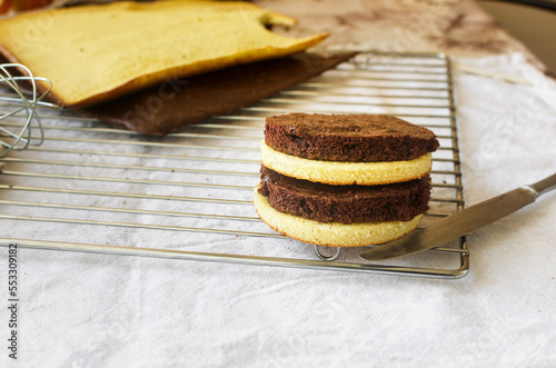 Freshly made homemade sponge cake shortcakes on metallic baking grid, photo