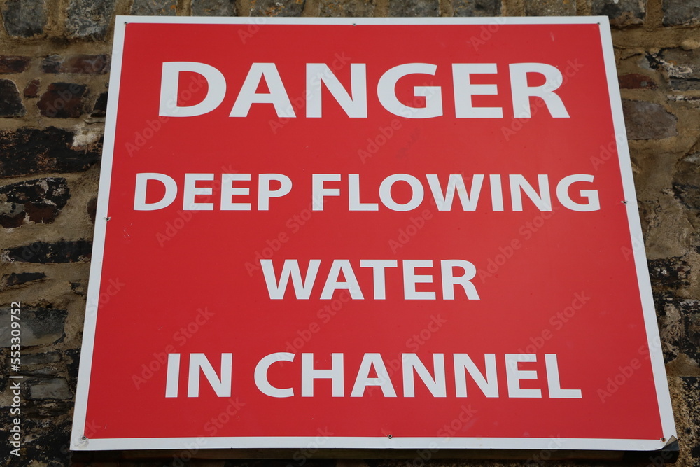 Danger deep flowing water in channel, Cornwall UK Danger deep flowing water in channel, Cornwall UK
