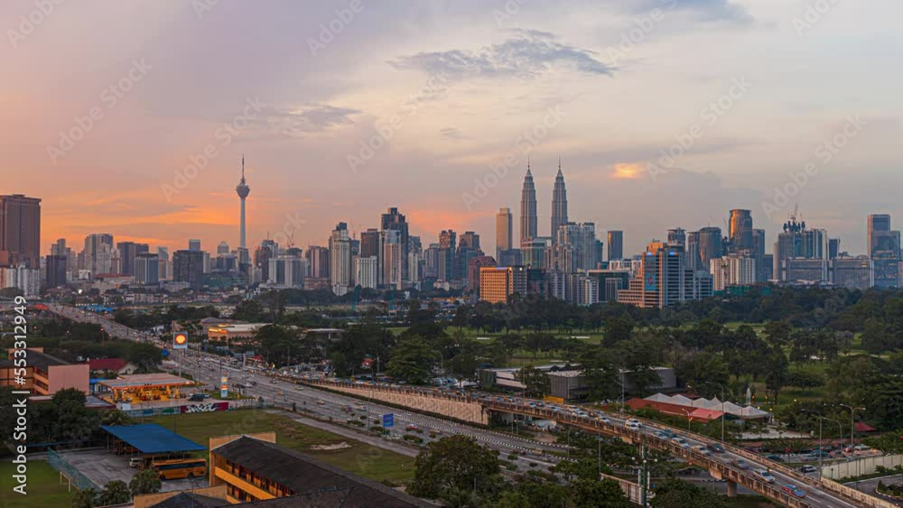 Aerial High Angle Time lapse view of busy city streets and golden sunset against a skyline in Kuala Lumpur, Malaysia. Prores 4KUHD. Aerial High Angle Time lapse view of busy city streets and golden sunset against a skyline in Kuala Lumpur, Malaysia. Prores 4KUHD.