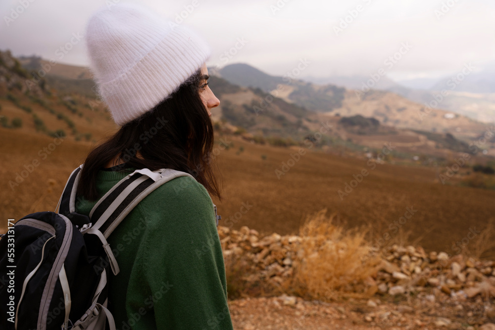 Lady tourist with a backpack standing on the mountain Lady tourist with a backpack standing on the mountain