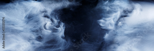 Panoramic view of the abstract fog. Cloudiness, mist or smog moves on black background. Beautiful swirling smoke. Mockup for your logo. Wide angle horizontal wallpaper or web banner.