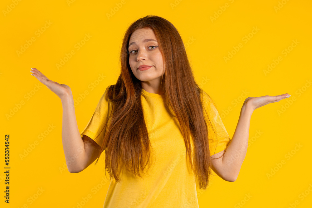 Confused pretty woman, shoulders up - can't help, makes gesture of I dont know. Difficult question, guilty reaction, puzzled stylish woman on yellow background. Confused pretty woman, shoulders up - can't help, makes gesture of I dont know. Difficult question, guilty reaction, puzzled stylish woman on yellow background.