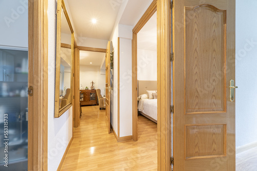Distributor corridor of an urban residential house with oak woodwork to match the floors and skirting
