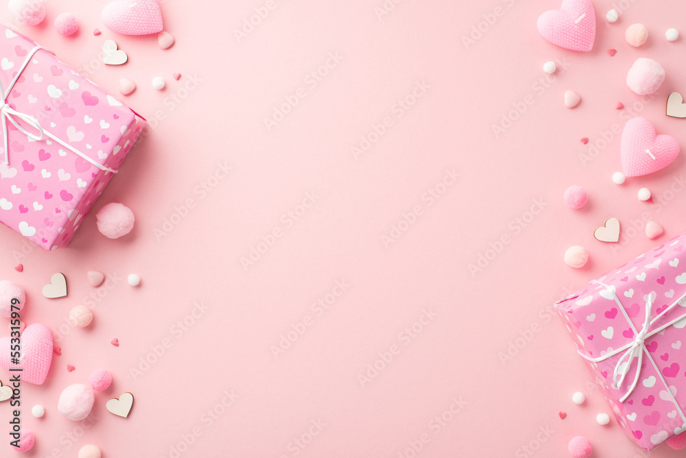 St Valentine's Day concept. Top view photo of present boxes heart shaped candles sprinkles and fluffy pompons on isolated pastel pink background with empty space St Valentine's Day concept. Top view photo of present boxes heart shaped candles sprinkles and fluffy pompons on isolated pastel pink background with empty space