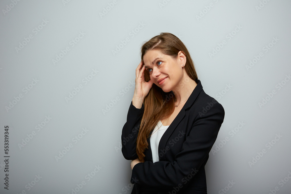 Smiling business woman in black suit looking at left side isolated profile portrait. Smiling business woman in black suit looking at left side isolated profile portrait.