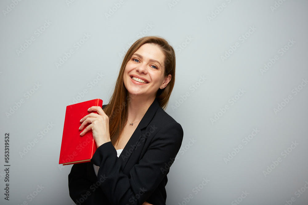 Smiling woman teacher holding red book. Isolated portrait with copy space. Smiling woman teacher holding red book. Isolated portrait with copy space.