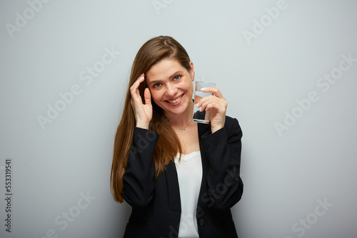 Smiling young woman holding glass with water. isolated female portrait.
