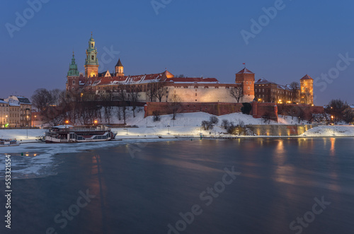 Krakow snowy winter, evening Wawel Castle over Vistula river, Poland