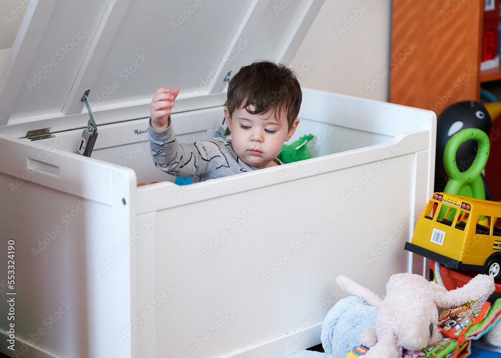 cute little boy throwing toys out of the toy box cute little boy throwing toys out of the toy box