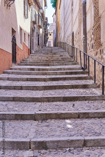 Vertical photo of some stairs of a narrow old street in a village. Selective focus. © Ernesto Sevilla