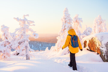 Young woman in winter forest in Finland