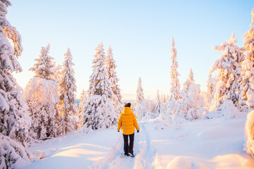 Young woman in winter forest in Finland