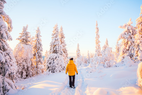 Young woman in winter forest in Finland © BlueOrange Studio