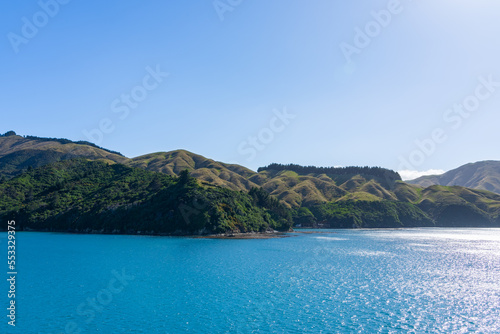 Passing scenic hills and bays while entering Marlborough Sounds by boat