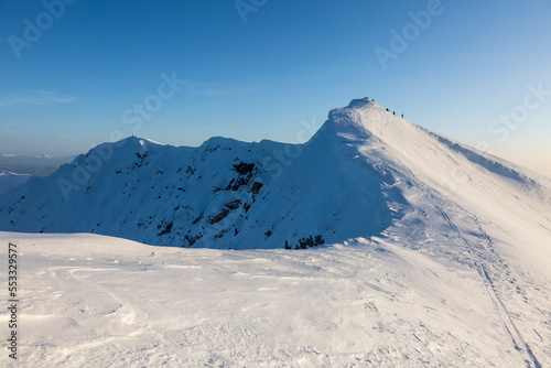 A snowy mountain range and steep slopes and cornices © almostfuture