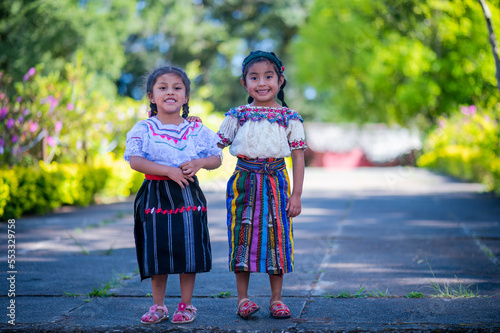 Retrato de dos  hermosas  niñas  indígena con un colorido vestido San Pedro Sacatepequez, Guatemala. 
 photo