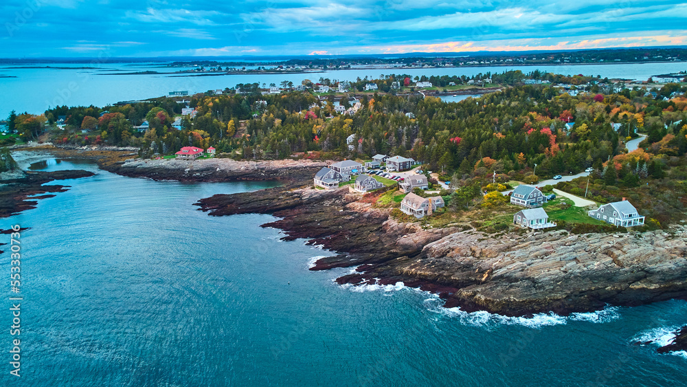 Dusk light aerial over coast of Maine with rocky cliffs and homes
