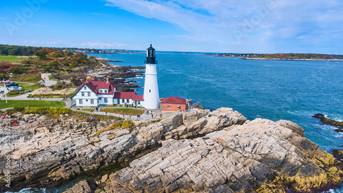 Rocky coastline aerial view of stunning Portland Head Light lighthouse in Maine