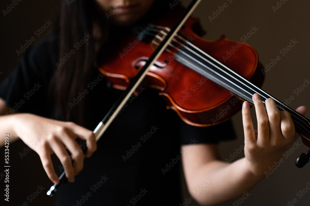 Teen playing violin in formal wear Teen playing violin in formal wear