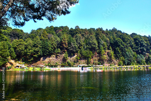 green lake and wood with blue sky in dam of the llano in villa del carbon state of mexico 