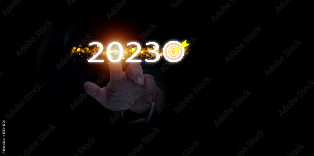 Businessman hand pointing virtual digital graphic 2023 year, preparing happy new year concept. New business in the new year begins,profit forecasting business, development of professional planning. - obrazy, fototapety, plakaty 