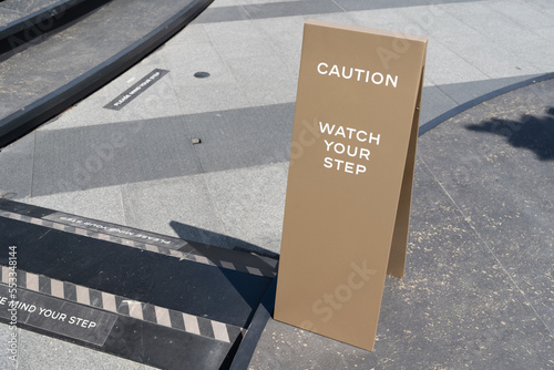 watch your step sign on the floor.