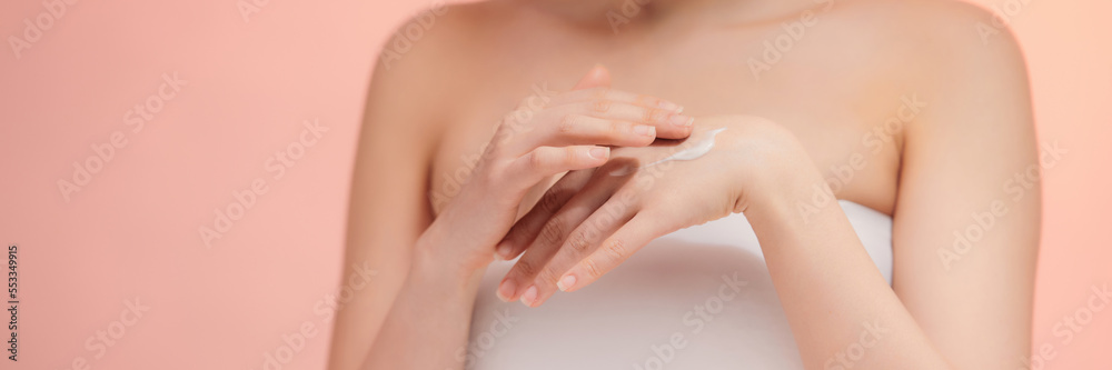 Woman in white t-shirt using hand skin care product